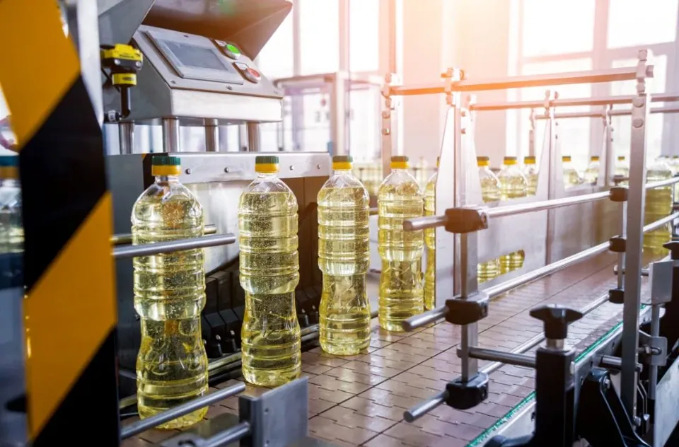 Bottles of cooking oil moving through a production line